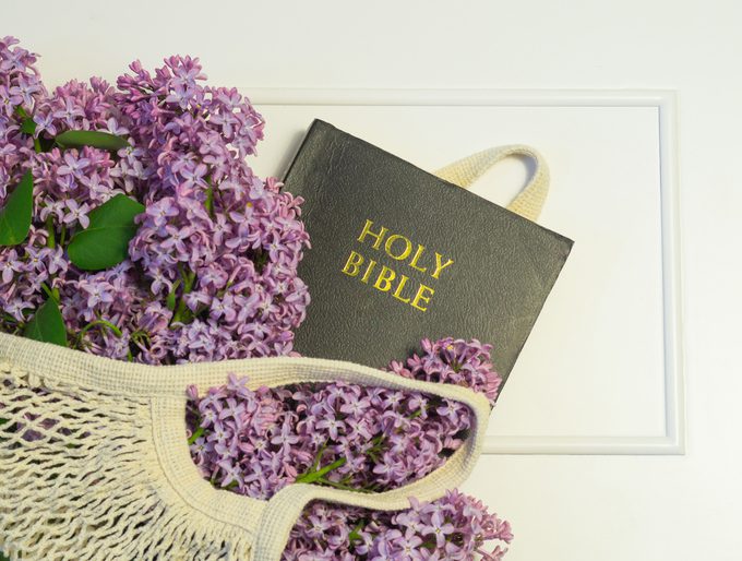 A photo of a bible and flowers